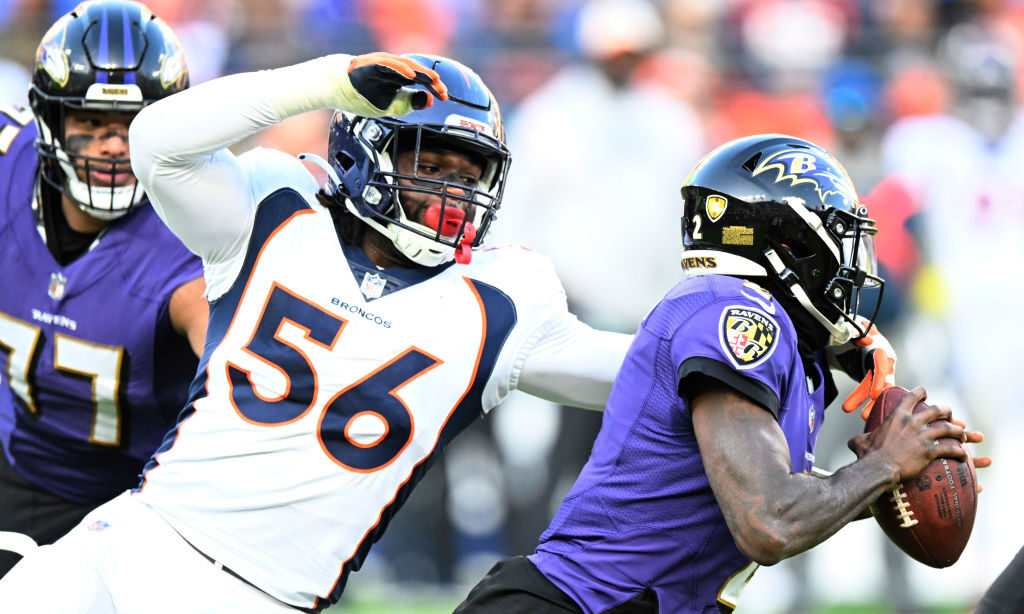 Baron Browning #56 of the Denver Broncos sacks Tyler Huntley...