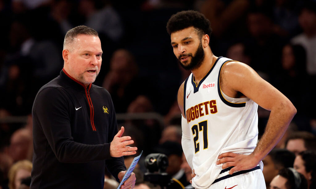 Head coach Michael Malone of the Denver Nuggets talks with Jamal Murray...